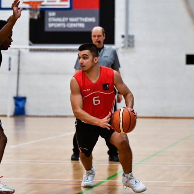 Staffs point guard number 6 drives to the left from the 3 pointer line under threat from the defence