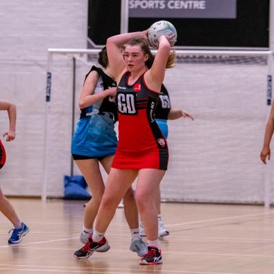 Goal defence takes an attempt at over head throwing the ball up the court