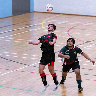 Staffs player jumps into the air to claim possession of the ball throw a header