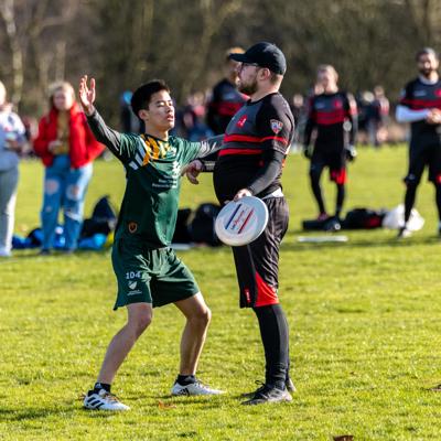 Staffs player waits to make a crucial pass to a teammate while Nottingham defend him 