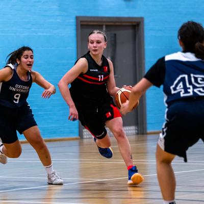 Point guard number 11 makes a drive through the middle of Oxfords defence