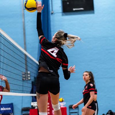 Staffs number 4 jumps into the air to spike the ball