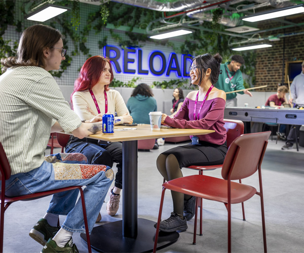 Students are sitting down socialising in the reload cafe area