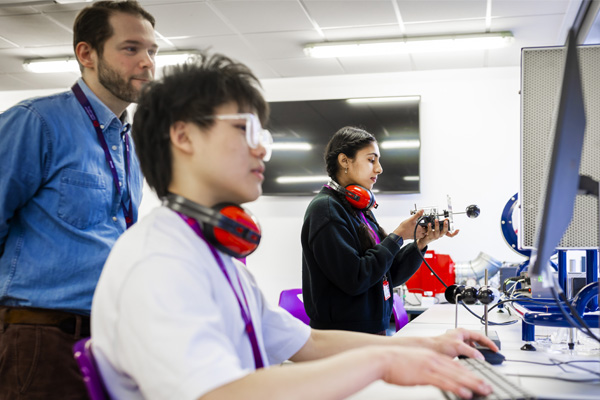 Students are in the lab using the equipment with the support of a lecturer