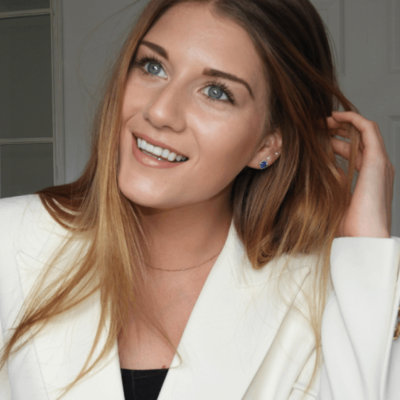 Emma is smiling brightly towards the left. 